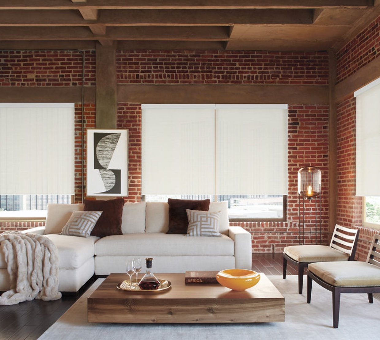 Roller shades in a brick-walled living room